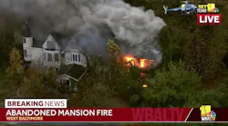 Baltimore firefighters are taking a defensive posture on an abandoned house fire.