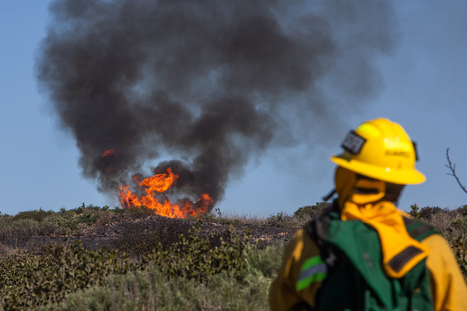A firefighter gives a report on a California wildfire.