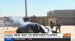 All firefighters have to do is lay the blanket over the car and wait until the flames are out.