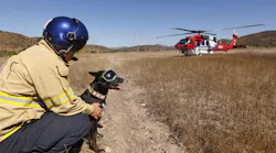 San Diego Fire Rescue Medic Chad Arberg sits with Cory before climbing into the helicopter.