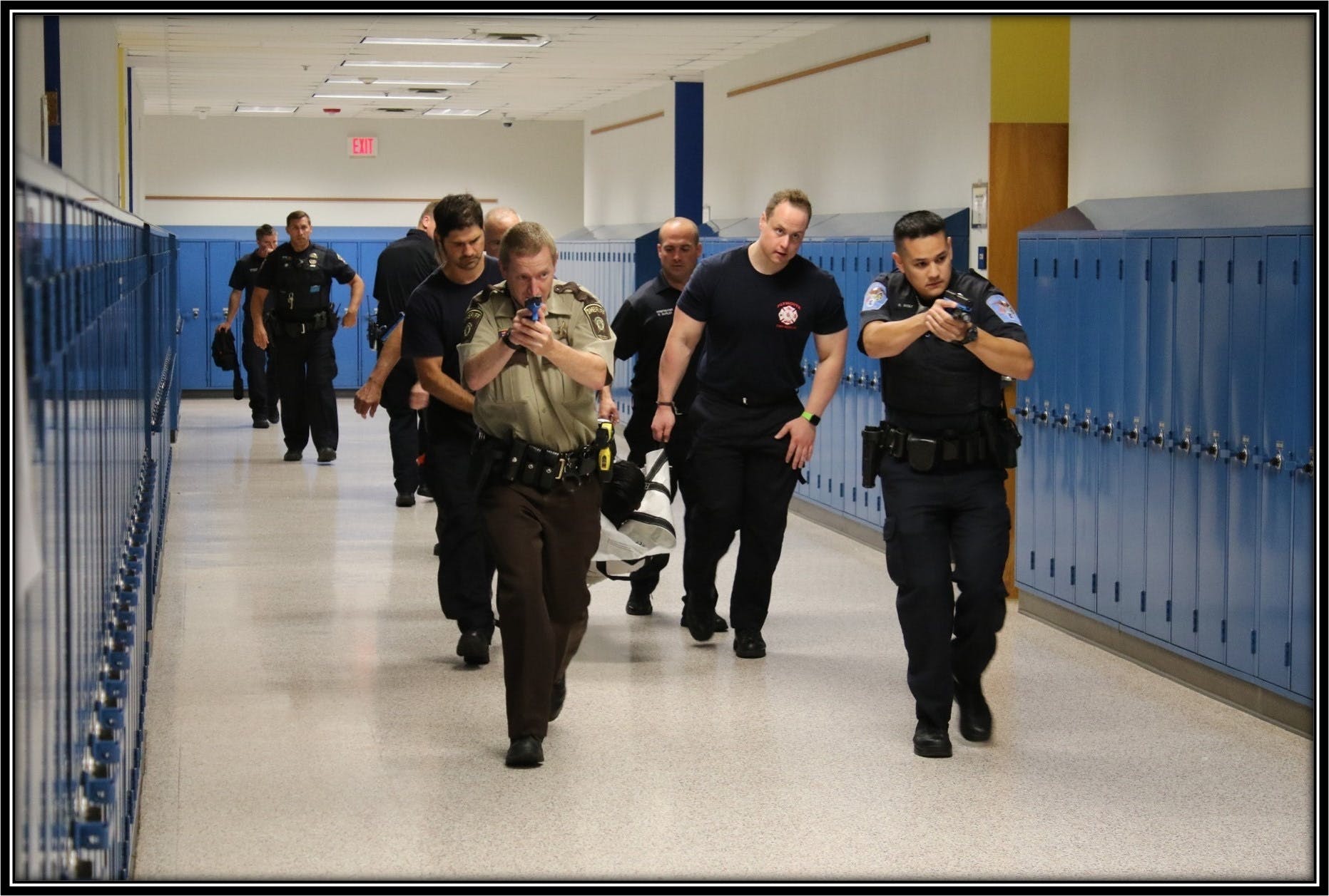 Police officers, firefighter and EMS crews evacuate a victim during an active shooter training scenario in Hennepin County.