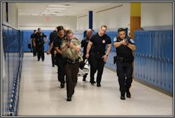 Police officers, firefighter and EMS crews evacuate a victim during an active shooter training scenario in Hennepin County. Police officers, firefighter and EMS crews evacuate a victim during an active shooter training scenario in Hennepin County.