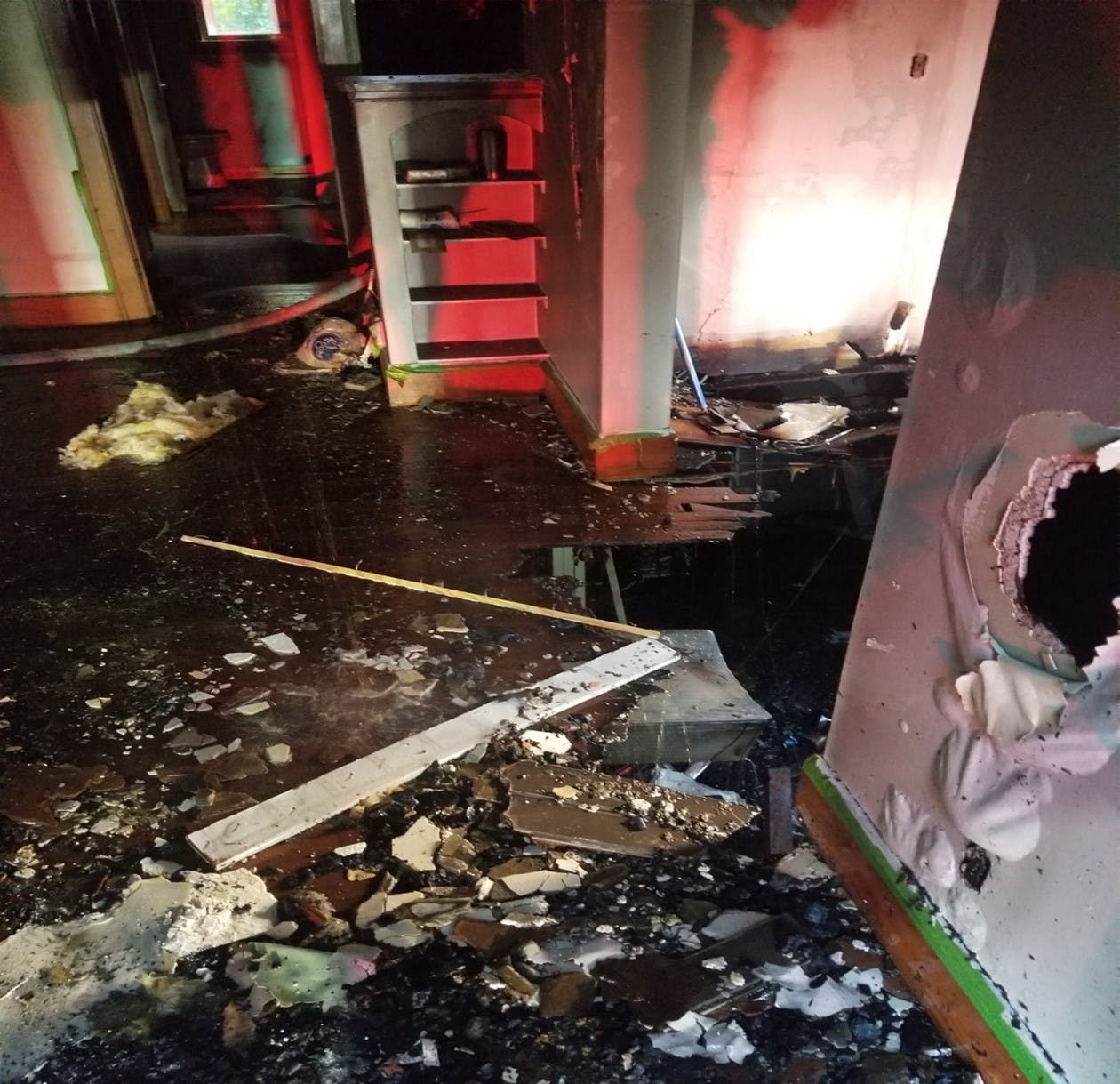 The firefighter (Victim 2) passed a firefighter who stumbled when he fell into the basement from the first floor. Despite multiple radio reports of holes in the floor, the injured firefighter and his crew said they were unaware of the holes.