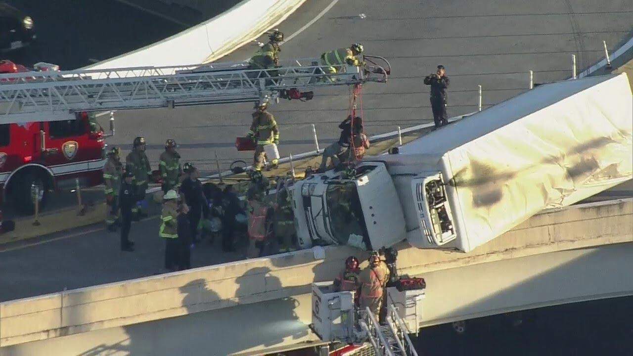 Driver rescued from truck hanging over Houston highway