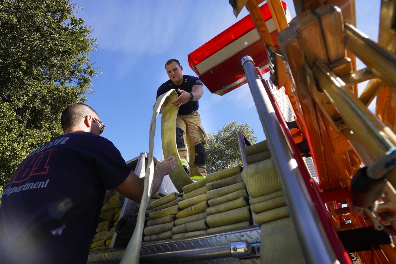 Rincon firefighters repack hose after a recent drill.