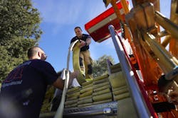 Rincon firefighters repack hose after a recent drill. Rincon firefighters repack hose after a recent drill.