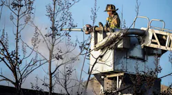 A firefighter trains a stream on a fire at the vacant William Penn School.