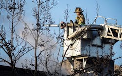A firefighter trains a stream on a fire at the vacant William Penn School. A firefighter trains a stream on a fire at the vacant William Penn School.