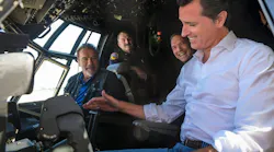 California Gov. Gavin Newsom, right, and former Gov. Arnold Schwarzenegger talk in a C-130 airplane cockpit with Cal Fire personnel at McClellan Airport near North Highlands in 2019.