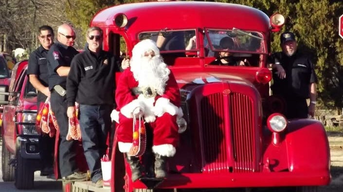 The stockings are handed out by Jacksboro firefighters and Santa Claus as they ride on their 1946 Seagrave pumper.