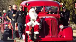 The stockings are handed out by Jacksboro firefighters and Santa Claus as they ride on their 1946 Seagrave pumper.