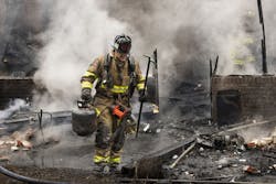 A firefighter operating at a structure fire.