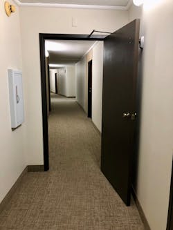 At apartment buildings, commercial buildings and high-rises, an electromagnetic door closure on a fire door causes the door to close when the alarm system is activated. This can trap firefighters behind the door with no water if a hoseline is trapped under the door opening. At apartment buildings, commercial buildings and high-rises, an electromagnetic door closure on a fire door causes the door to close when the alarm system is activated. This can trap firefighters behind the door with no water if a hoseline is trapped under the door opening.