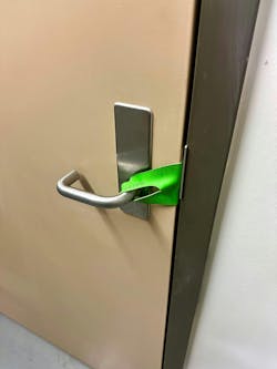 The benefit of a latch strap over a spring clamp is that a latch strap allows a door to be fully closed, which minimizes smoke spread but still allows access.