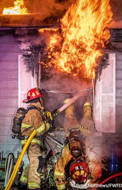 Capt. Brian Alexander clears the window frame after bailing out from the burning room. Capt. Brian Alexander clears the window frame after bailing out from the burning room.