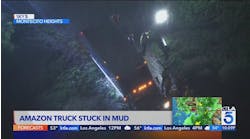 Amazon truck stuck in mud, threatens homes below