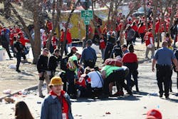 Police and EMS personnel tend to victims following a shooting during the Kansas City Chiefs Super Bowl LVIII victory parade on Feb. 14, 2024, in Kansas City.