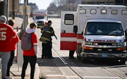 A firefighter works near an ambulance after several people were shot near Union Station during the Kansas City Chiefs&apos; Super Bowl LVIII victory parade.