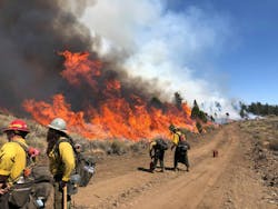 Firefighters engage in firing operations to reinforce a two-track road that’s being used for perimeter control. Firefighters engage in firing operations to reinforce a two-track road that’s being used for perimeter control.