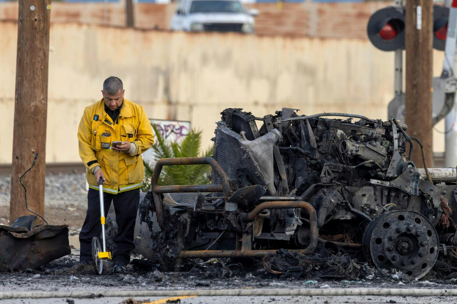 A Los Angeles Fire Department investigator works at the the scene of a truck explosion that injured nine firefighters, two critically injured Thursday. All but one of the firefighters has been released from the hospital.