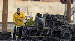 A Los Angeles Fire Department investigator works at the the scene of a truck explosion that injured nine firefighters, two critically injured Thursday. All but one of the firefighters has been released from the hospital.