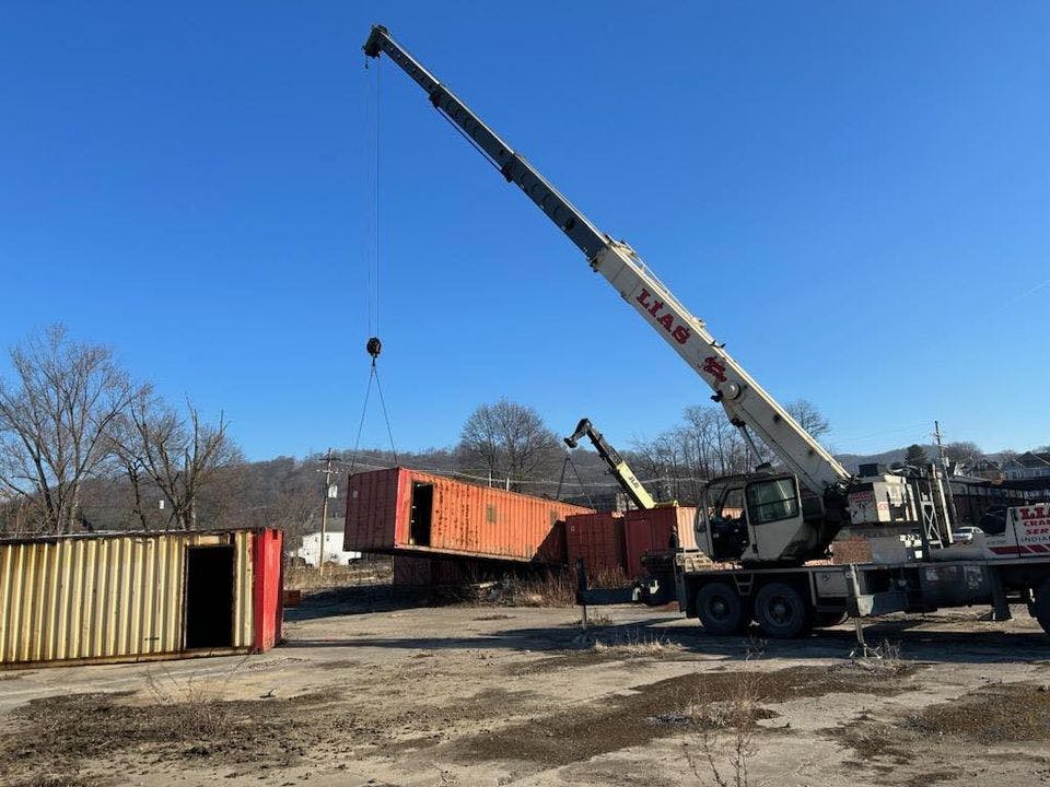 JWF Industries workers are reinstalling the three-story six-pod structure.
