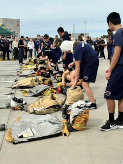 The first event included Fire Explorers donning gear before rolling hose. The first event included Fire Explorers donning gear before rolling hose.