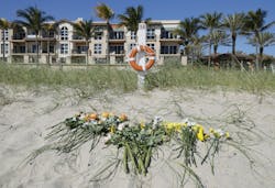 Flowers were placed along the beach to honor a girl died when she was buried in a sand hole.