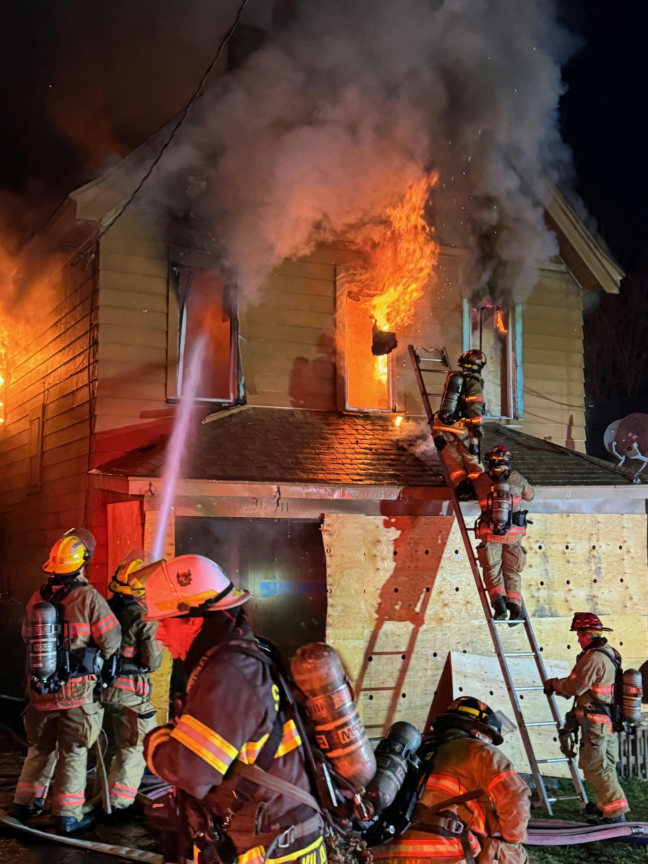 Firefighters found flames and smoke coming from the rear of the 2 1/2-story home in Syracuse.