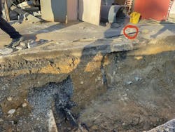 Wispy white smoke was emanating from a crack (red circle) in a curb in a parking lot that was adjacent to the communications closet (and adjoining electrical closet) when members of FCFRD’s Engine 410 arrived. The path of the service lines to the sidewalk also are visible. To its left is the communications conduit, to which the underground event migrated. Wispy white smoke was emanating from a crack (red circle) in a curb in a parking lot that was adjacent to the communications closet (and adjoining electrical closet) when members of FCFRD’s Engine 410 arrived. The path of the service lines to the sidewalk also are visible. To its left is the communications conduit, to which the underground event migrated.