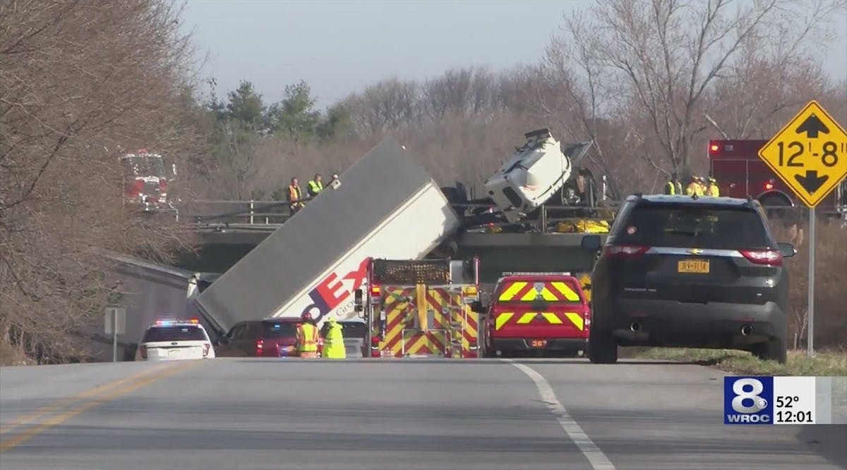 WATCH: Tractor-trailer hangs over bridge, driver and family injured