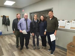 Packaging And Crating Technologies (PACT®), a US-based manufacturer of a patented, fire-suppressant paper wrap and BS Technics Company, a thermal interface material company in Korea, recently announced an exclusive partnership that allows the expansion of PACT® Thermo ShieldTM and TR SleeveTM, products that control deadly lithium-ion battery fires, into the Asian country. (from left): Larry Nussbaum, president of PACT, Rodger Mort, COO at PACT, Alan Goodrich, sales and marketing manager at PACT, Richard Kwon, chief marketing officer at BS Technics Company and Jennifer Kim, director of sales and marketing at BS Technics Company celebrate their new exclusive partnership at PACT’s Watertown, Conn headquarters. Packaging And Crating Technologies (PACT®), a US-based manufacturer of a patented, fire-suppressant paper wrap and BS Technics Company, a thermal interface material company in Korea, recently announced an exclusive partnership that allows the expansion of PACT® Thermo ShieldTM and TR SleeveTM, products that control deadly lithium-ion battery fires, into the Asian country. (from left): Larry Nussbaum, president of PACT, Rodger Mort, COO at PACT, Alan Goodrich, sales and marketing manager at PACT, Richard Kwon, chief marketing officer at BS Technics Company and Jennifer Kim, director of sales and marketing at BS Technics Company celebrate their new exclusive partnership at PACT’s Watertown, Conn headquarters.