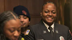 St. Paul Fire Capt. Brittney Baker listens to her daughter, Naaziah Baker, 15, read a St. Paul City Council resolution honoring her mother in St. Paul City Council Chambers on March 27.