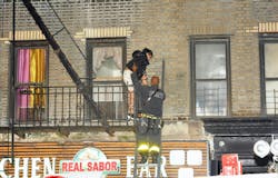 An FDNY firefighter rescues a resident at the March 20 fire where three children were left at home alone. An FDNY firefighter rescues a resident at the March 20 fire where three children were left at home alone.
