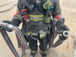 By marking the halfway points of an uncharged hoseline (shown here draped over the firefighter's arms), the firefighter can easily reposition the hoseline when a new position is required compared with the first positioning. After the hoseline is moved and the nozzle and coupling are set down at the desired entry point of the fire building, the firefighter walks back to the halfway points. By marking the halfway points of an uncharged hoseline (shown here draped over the firefighter's arms), the firefighter can easily reposition the hoseline when a new position is required compared with the first positioning. After the hoseline is moved and the nozzle and coupling are set down at the desired entry point of the fire building, the firefighter walks back to the halfway points.