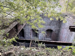 The steel I-beam to the left made for a difficult edge transition during the RFD’s rope recovery. The overgrown vegetation and dirt initially was thought to be a cliff’s edge. In fact, the entire location was atop other roof sections. The steel I-beam to the left made for a difficult edge transition during the RFD’s rope recovery. The overgrown vegetation and dirt initially was thought to be a cliff’s edge. In fact, the entire location was atop other roof sections.