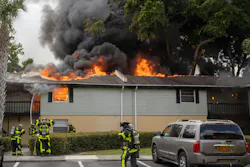 Firefighters work to extinguish a 3-alarm fire at the The Hamptons at Brandon Condominiums on Sunday.