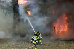 Firefighters work to extinguish a 3-alarm fire at the The Hamptons at Brandon Condominiums on Sunday.