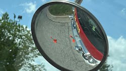 The photograph on the left was taken from the engineer's sitting position. Cones that are positioned one feet and seven feet from the front bumper aren't visible. The cones are visible in the spotter mirror (right). The photograph on the left was taken from the engineer's sitting position. Cones that are positioned one feet and seven feet from the front bumper aren't visible. The cones are visible in the spotter mirror (right).