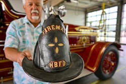 Terry Hibler shows off a 100-year-old helmet worn by his grandfather, a volunteer Huntington Beach firefighter. Terry Hibler shows off a 100-year-old helmet worn by his grandfather, a volunteer Huntington Beach firefighter.