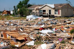 Debris surrounds a home in Valley View, TX, the morning after severe storms moved through Denton and Cooke counties Saturday night.