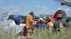 The pilot is removed from the crash site.