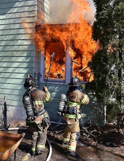 While en route, Chief 3 reported heavy smoke and advised that the fire building was a two-story hoarder house that had windows and doors boarded. On arrival, the house was well involved. While en route, Chief 3 reported heavy smoke and advised that the fire building was a two-story hoarder house that had windows and doors boarded. On arrival, the house was well involved.