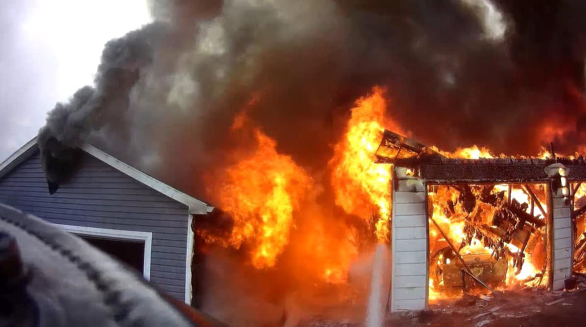 Two firefighters were briefly trapped in the garage.