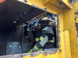 When rescuers entered the mulcher, they determined that there wasn’t entrapment but found that the victim was sitting precariously on a 6 x 4-inch metal beam. That plus the severity of the leg injury and the limited space with which to work dictated the use of the aerial. When rescuers entered the mulcher, they determined that there wasn’t entrapment but found that the victim was sitting precariously on a 6 x 4-inch metal beam. That plus the severity of the leg injury and the limited space with which to work dictated the use of the aerial.