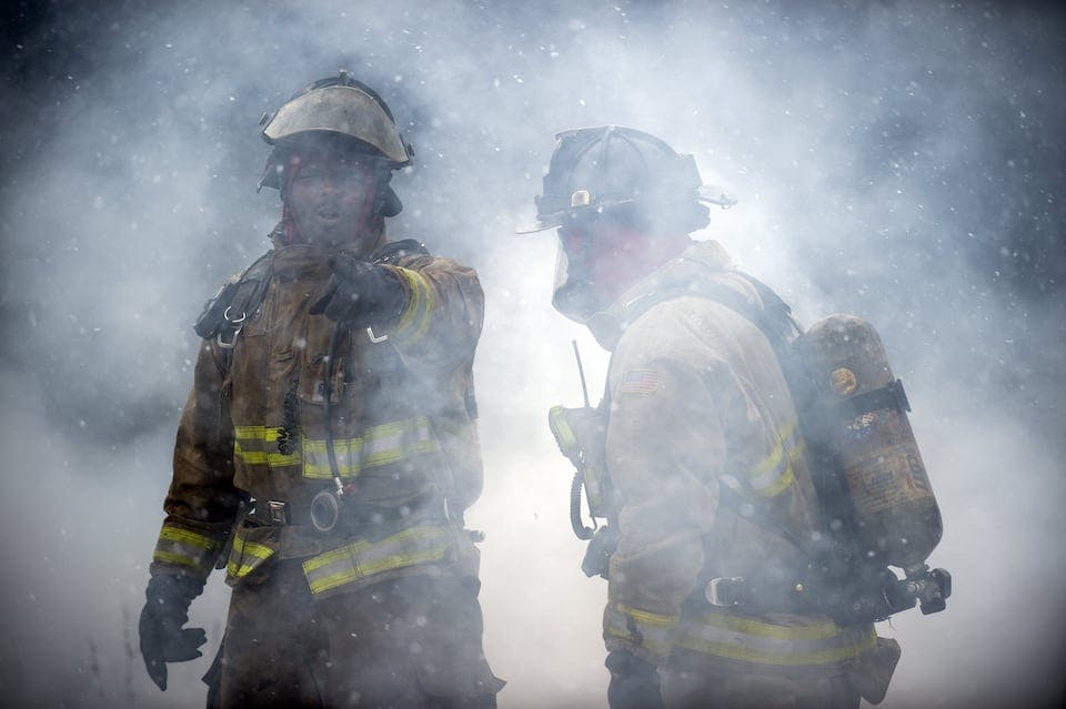 Two Flint firefighters operate at a recent fire.