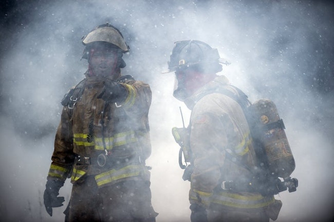 Two Flint firefighters operate at a recent fire.