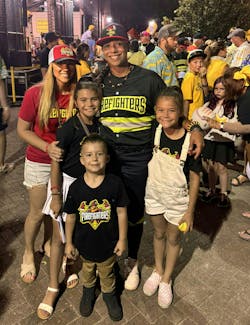 Head coach Valerie Perez, a Corpus Christi, TX, firefighter, and her family after a game. Head coach Valerie Perez, a Corpus Christi, TX, firefighter, and her family after a game.