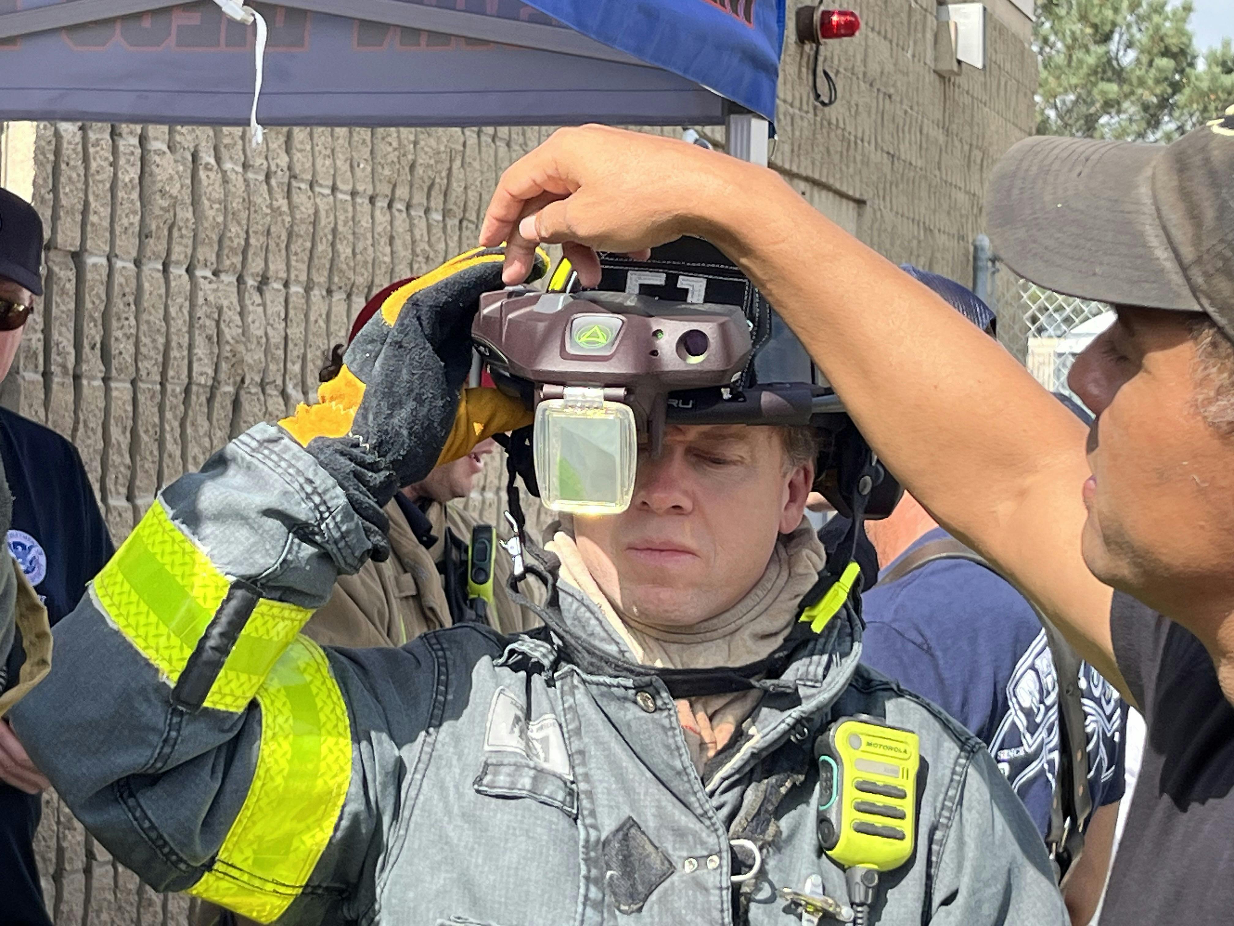 A firefighter receives training on the heads-up display of the C-THRU Navigator during the testing process.