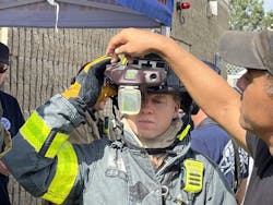 A firefighter receives training on the heads-up display of the C-THRU Navigator during the testing process.